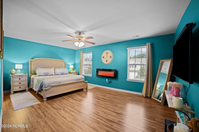 bedroom with ceiling fan and light hardwood / wood-style flooring