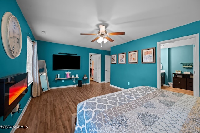 bedroom featuring wood-type flooring, ceiling fan, and ensuite bath