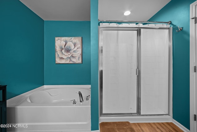 bathroom with separate shower and tub and hardwood / wood-style floors