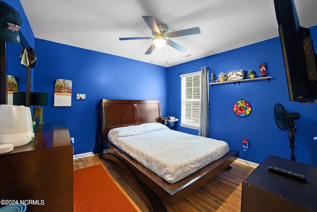 bedroom with hardwood / wood-style flooring and ceiling fan