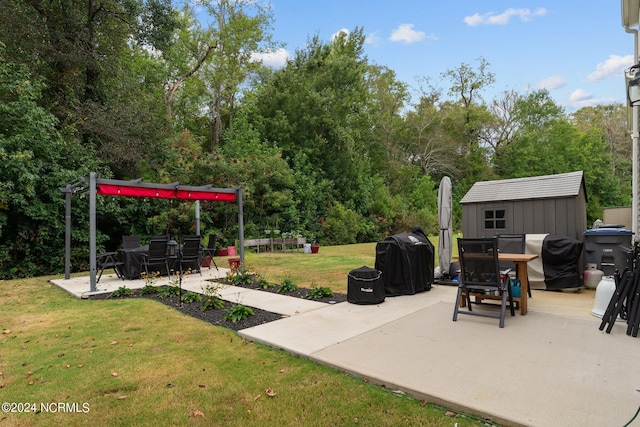 view of patio with a storage unit and a grill