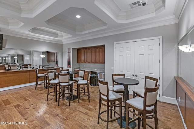 dining room featuring beamed ceiling, crown molding, coffered ceiling, and light hardwood / wood-style floors