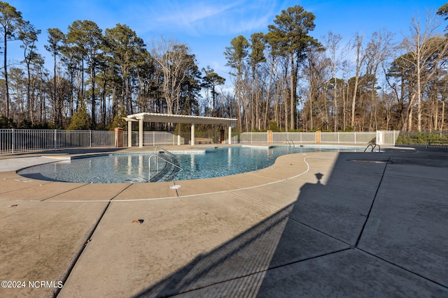 view of swimming pool with a patio area and a pergola