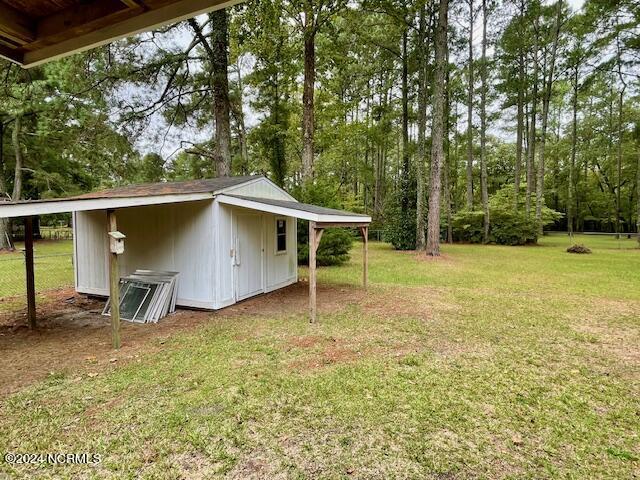 view of yard featuring an outbuilding and a carport