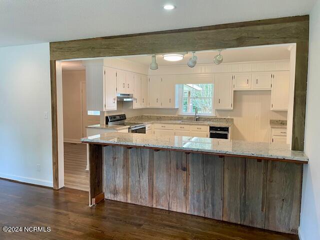 kitchen featuring stainless steel range with electric stovetop, light stone countertops, kitchen peninsula, and white cabinetry