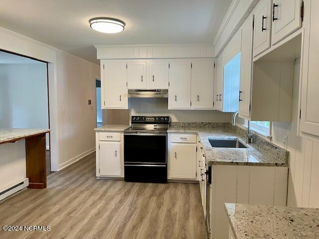 kitchen featuring under cabinet range hood, ornamental molding, range with electric stovetop, white cabinets, and a sink