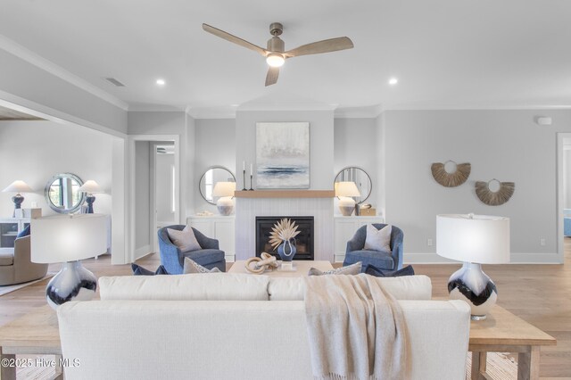 616 Waterstone Dr, Wilmington, NC 28411 - living room featuring ornamental molding, recessed lighting, ceiling fan, a glass covered fireplace, and wood finished floors