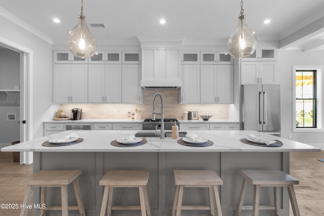 616 Waterstone Dr, Wilmington, NC 28411 - kitchen with high quality fridge, light wood finished floors, ornamental molding, decorative light fixtures, and backsplash