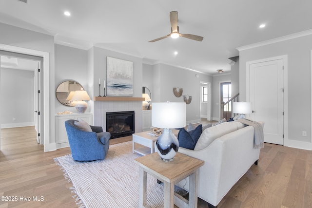 616 Waterstone Dr, Wilmington, NC 28411 - living area with crown molding, ceiling fan, baseboards, a fireplace, and light wood-type flooring
