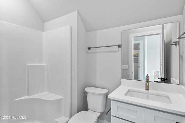 616 Waterstone Dr, Wilmington, NC 28411 - bathroom with vanity, toilet, lofted ceiling, and a shower