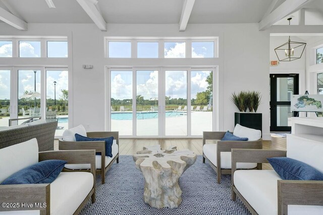 616 Waterstone Dr, Wilmington, NC 28411 - living room with beamed ceiling, a chandelier, hardwood / wood-style floors, and a towering ceiling