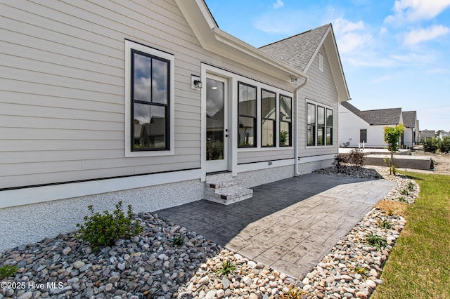 616 Waterstone Dr, Wilmington, NC 28411 - view of side of home featuring a patio area, entry steps, and roof with shingles