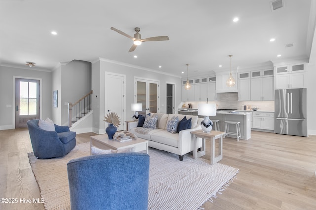 616 Waterstone Dr, Wilmington, NC 28411 - living room featuring recessed lighting, crown molding, light wood-style flooring, baseboards, and stairs