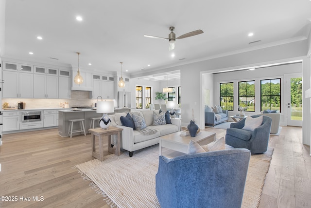 616 Waterstone Dr, Wilmington, NC 28411 - living area with plenty of natural light, recessed lighting, ornamental molding, light wood-type flooring, and a ceiling fan
