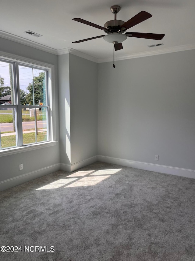 spare room with carpet flooring, ornamental molding, and ceiling fan