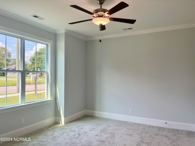 carpeted spare room with crown molding and ceiling fan