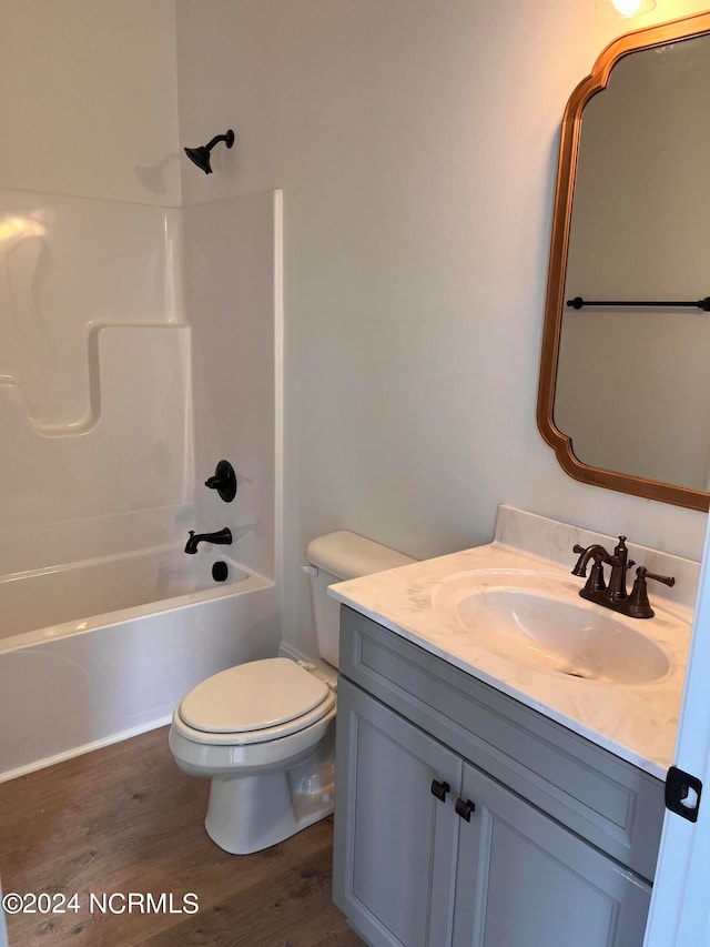 full bathroom with shower / bath combination, hardwood / wood-style flooring, vanity, and toilet