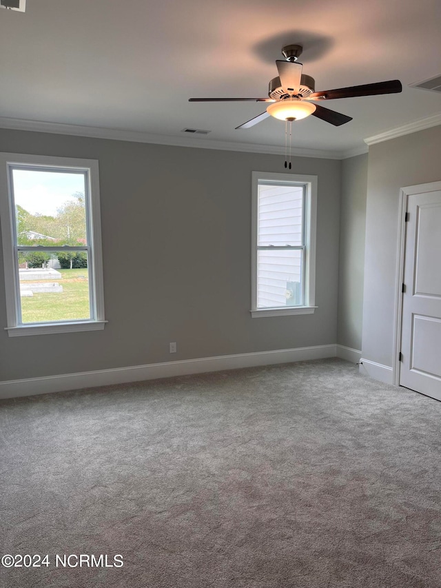 unfurnished room with carpet flooring, ornamental molding, and ceiling fan