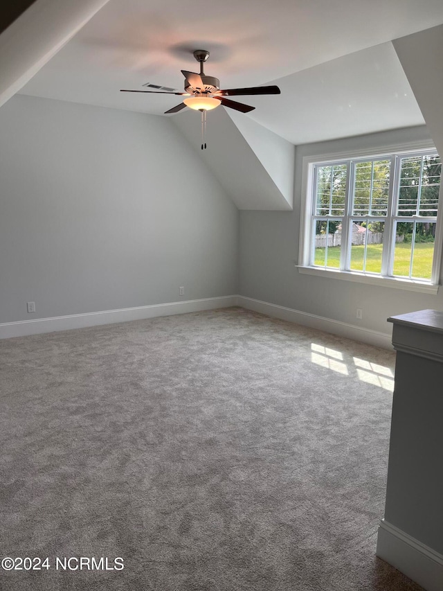 bonus room with lofted ceiling, ceiling fan, and carpet flooring