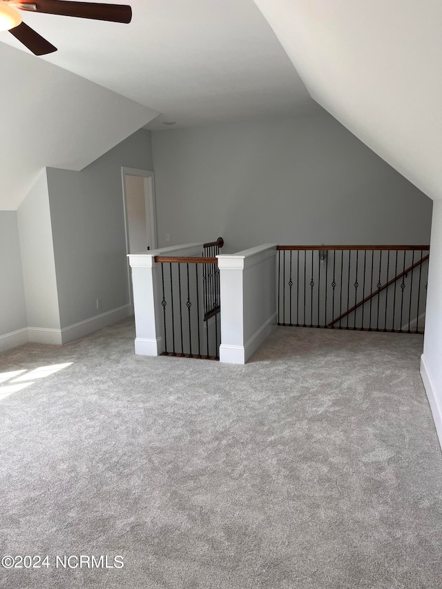 bonus room with ceiling fan, lofted ceiling, and carpet