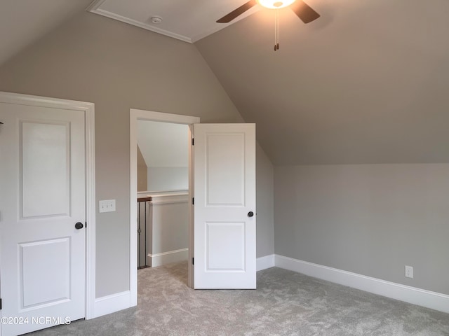 bonus room with vaulted ceiling, ceiling fan, and light carpet