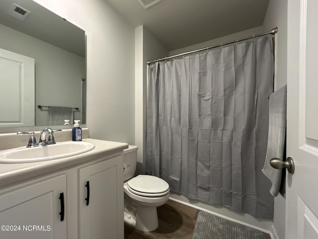 full bathroom featuring shower / tub combo, vanity, and toilet