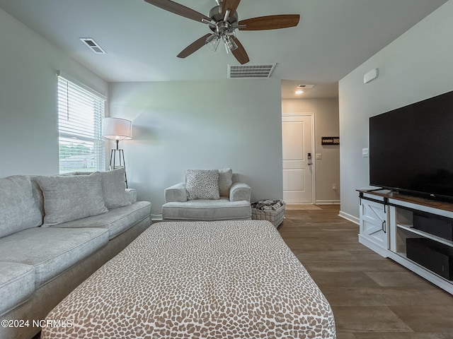 living room featuring ceiling fan and dark hardwood / wood-style floors