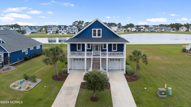 view of front of home featuring a water view, a porch, a garage, and a front lawn