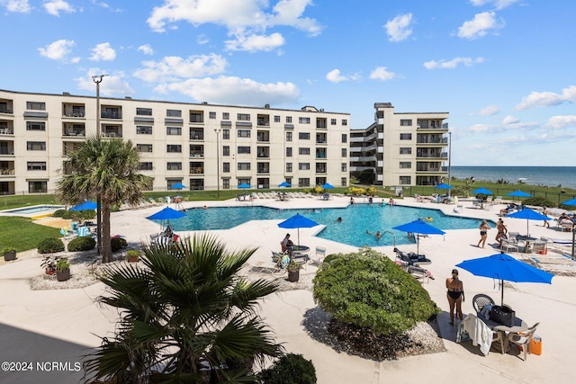 view of swimming pool with a water view