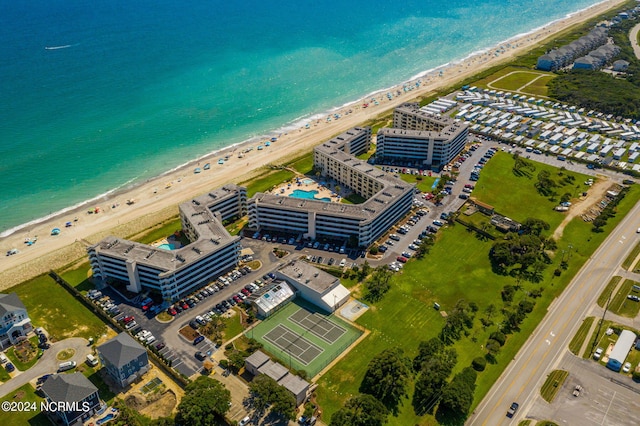 bird's eye view featuring a water view and a beach view