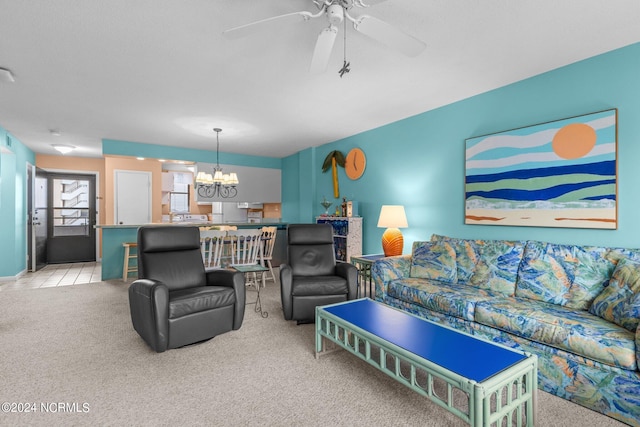 carpeted living room featuring ceiling fan with notable chandelier