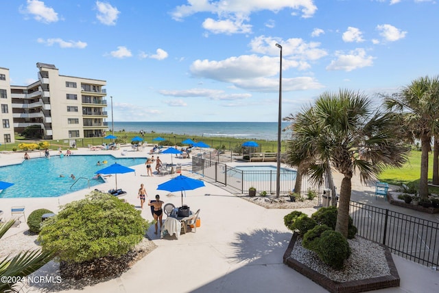 view of swimming pool featuring a water view