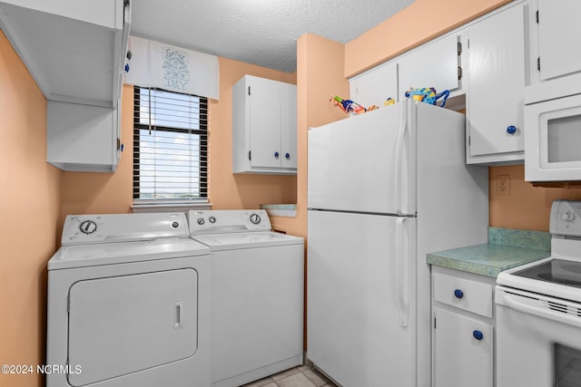 laundry room with separate washer and dryer, a textured ceiling, and light tile patterned floors