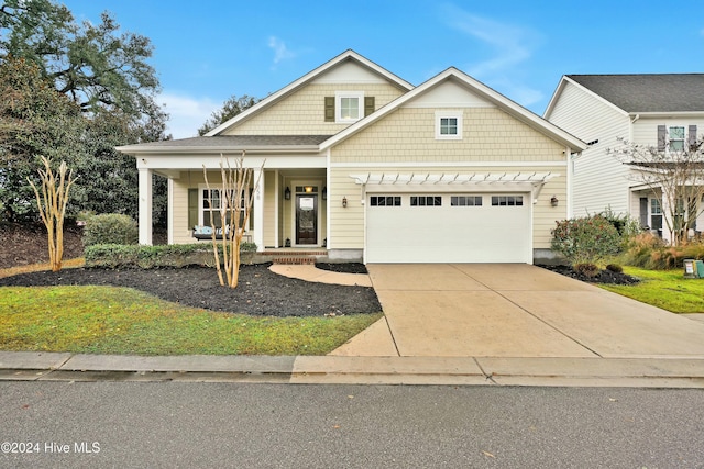 view of front of property with covered porch and a garage