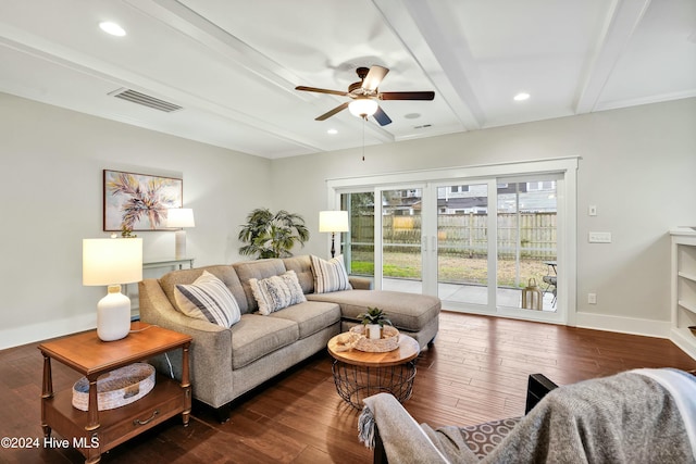 living room with ceiling fan, beamed ceiling, and dark wood-type flooring