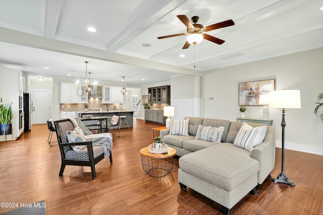 living room featuring beam ceiling, hardwood / wood-style floors, and ceiling fan with notable chandelier