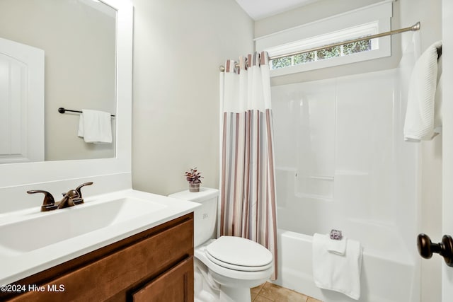 full bathroom featuring tile patterned flooring, shower / bath combo, vanity, and toilet