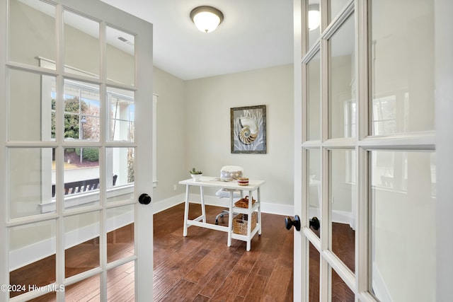 office with dark hardwood / wood-style flooring and french doors