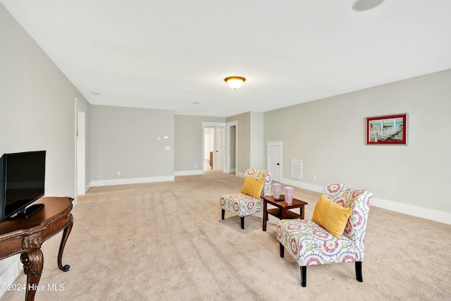 living area with light carpet