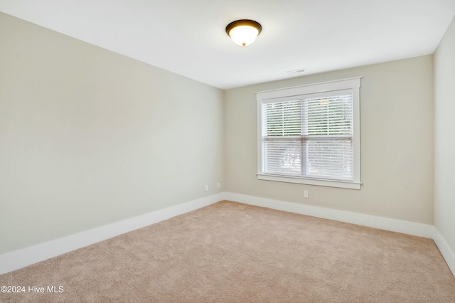 unfurnished room with light carpet