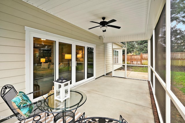 sunroom / solarium featuring ceiling fan