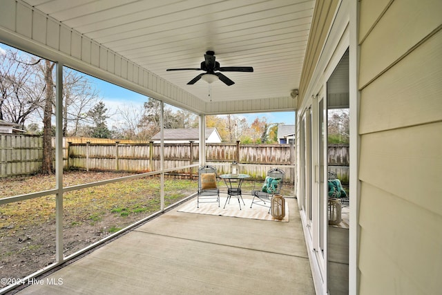 unfurnished sunroom featuring ceiling fan