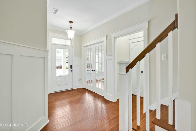 entryway featuring hardwood / wood-style floors, french doors, and ornamental molding