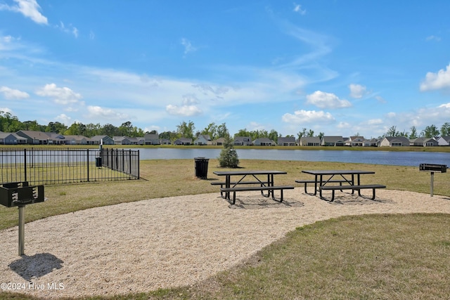 view of home's community featuring a yard and a water view