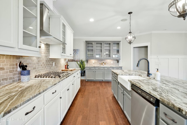 kitchen featuring gray cabinetry, stainless steel appliances, dark wood-type flooring, sink, and wall chimney range hood