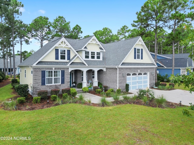 craftsman house with a porch, a front yard, and a garage