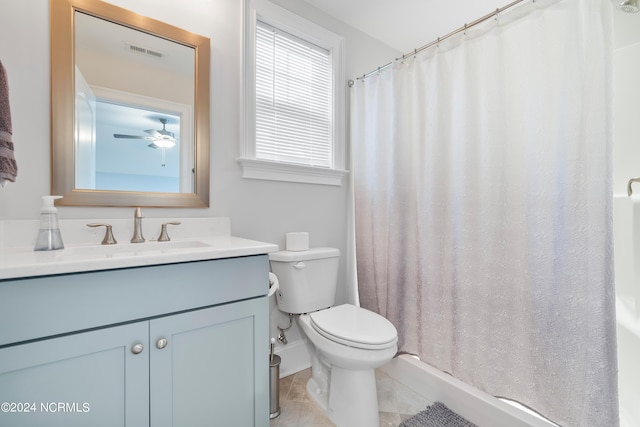 bathroom with vanity, toilet, a shower with curtain, and tile patterned flooring