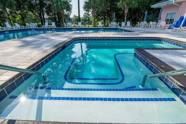 view of swimming pool featuring a patio area