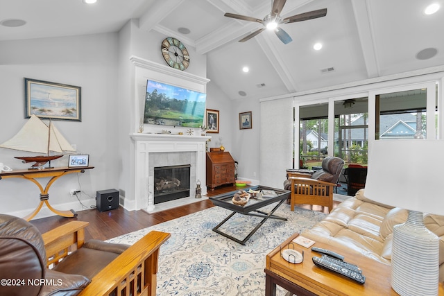 living room with dark hardwood / wood-style floors, lofted ceiling with beams, a tile fireplace, and ceiling fan