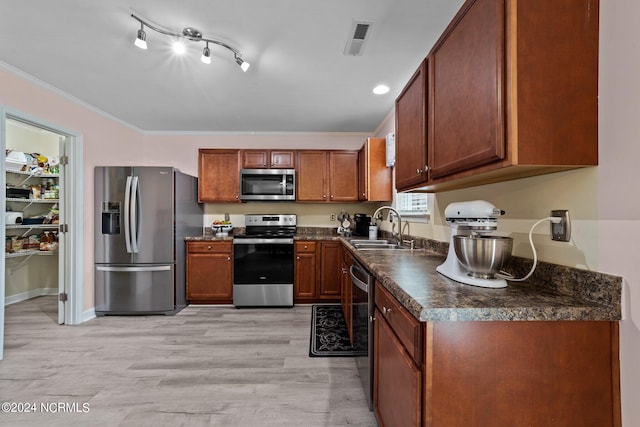 kitchen featuring light hardwood / wood-style floors, appliances with stainless steel finishes, crown molding, and sink